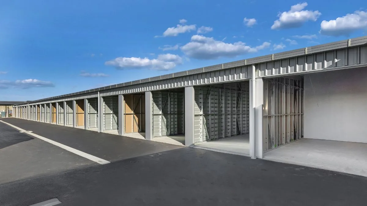 A row of drive-up storage units with their roller doors open at LocknLeave Rolleston
